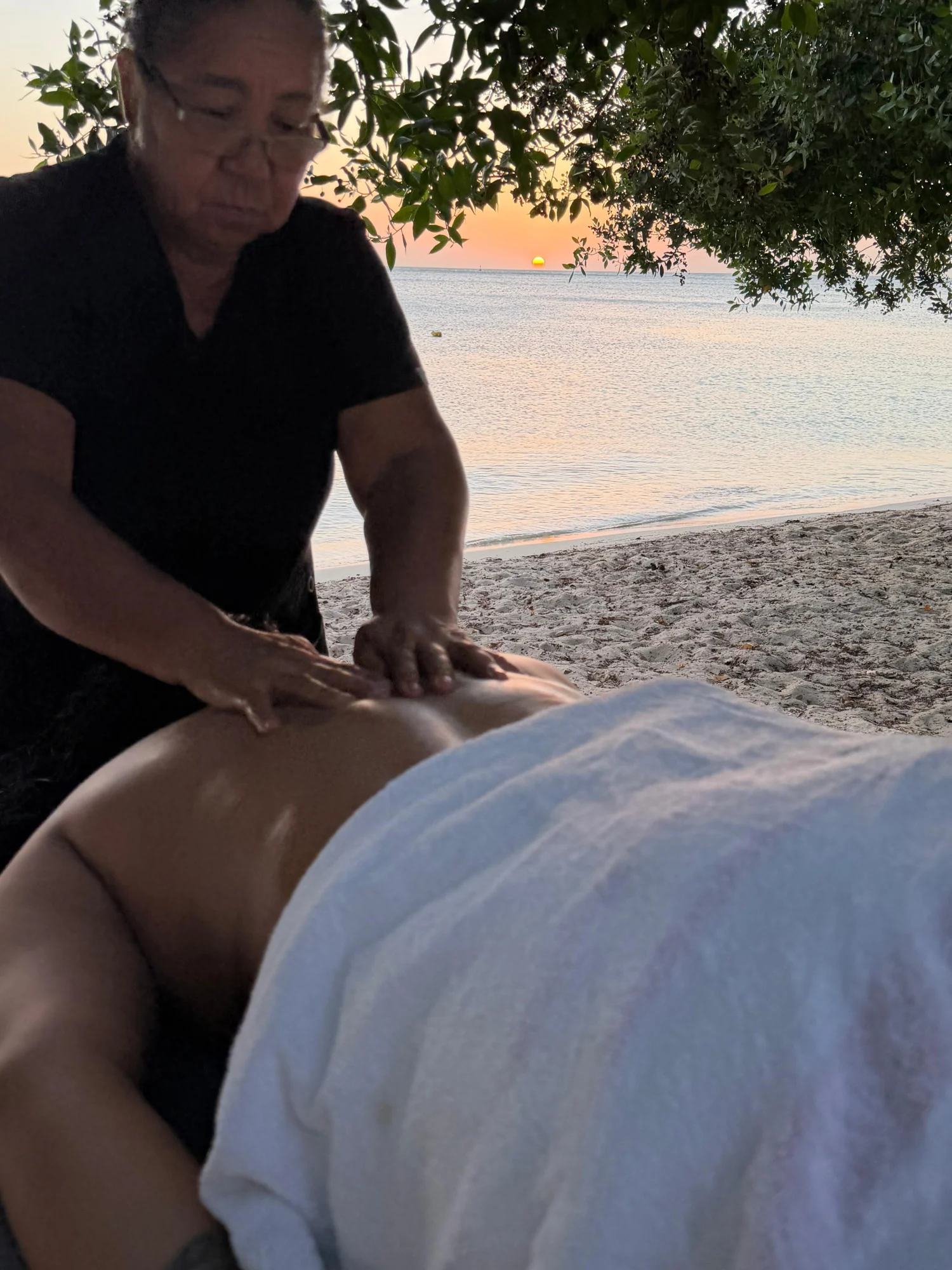 Couples beach massage in Aruba at sunset